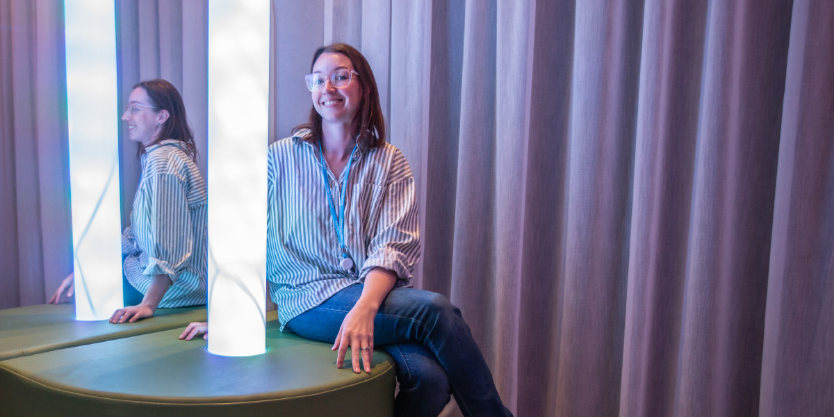 Person using a sensory light feature in the Sensory Space.