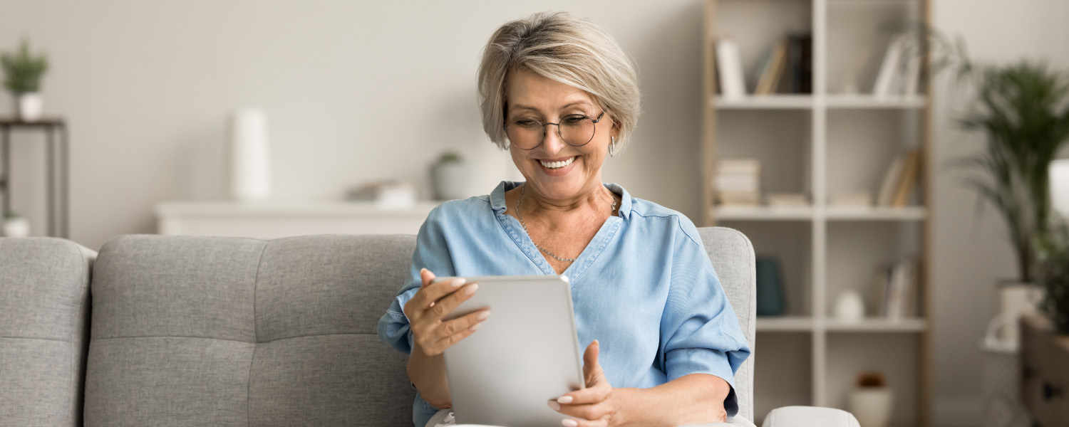 Library member using a tablet to read an e-book.